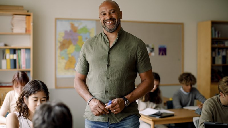 Teacher standing in classroom with students